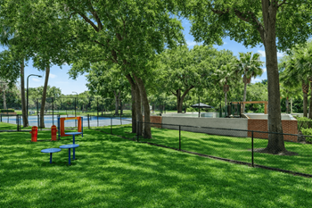 A park with a blue bench and a red object.